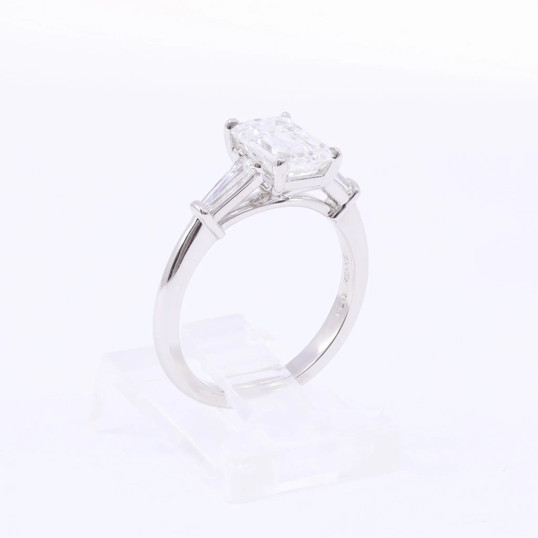 PLATINUM HENNE-FIT EMERALD-CUT DIAMOND AND TAPERED BAGUETTE THREE-STONE ENGAGEMENT RING